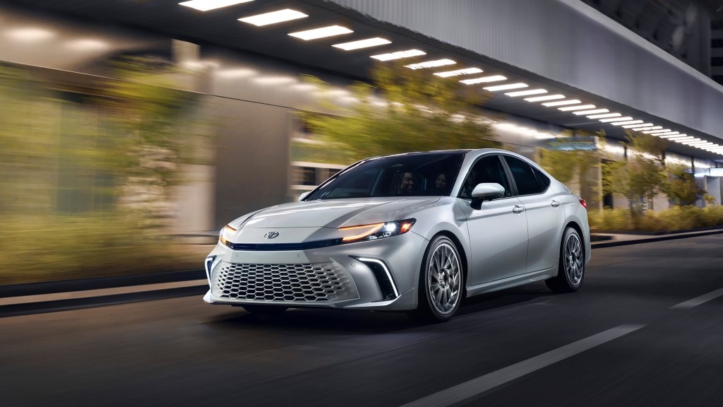 2025 Toyota Camry Silver Camry driving city streets at night