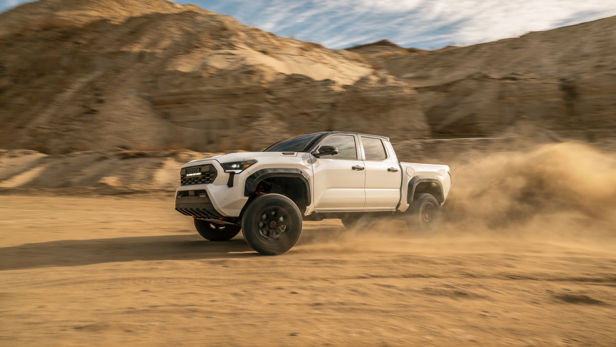 2025 Toyota Tacoma i-FORCE MAX White 2025 Toyota Tacoma i-FORCE MAX drifting in the dessert