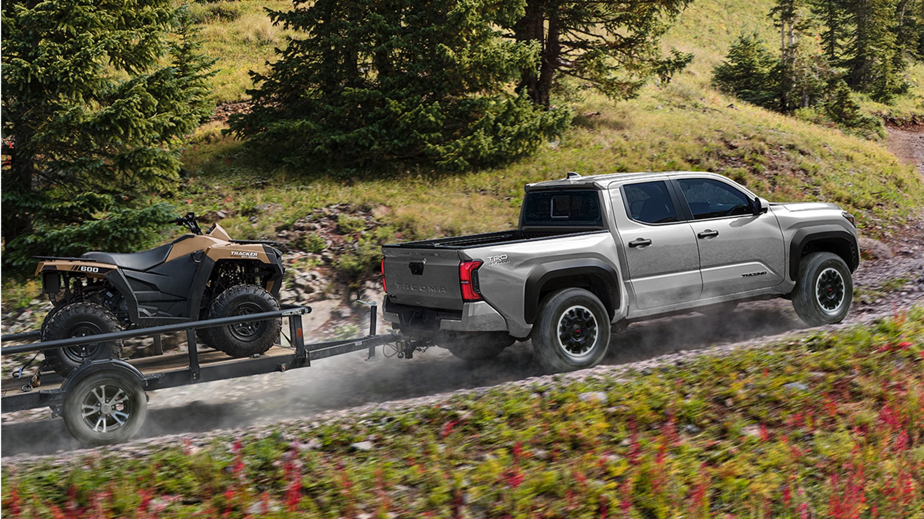 2026 Toyota Tacoma Tacoma driving on dirt road across hillside