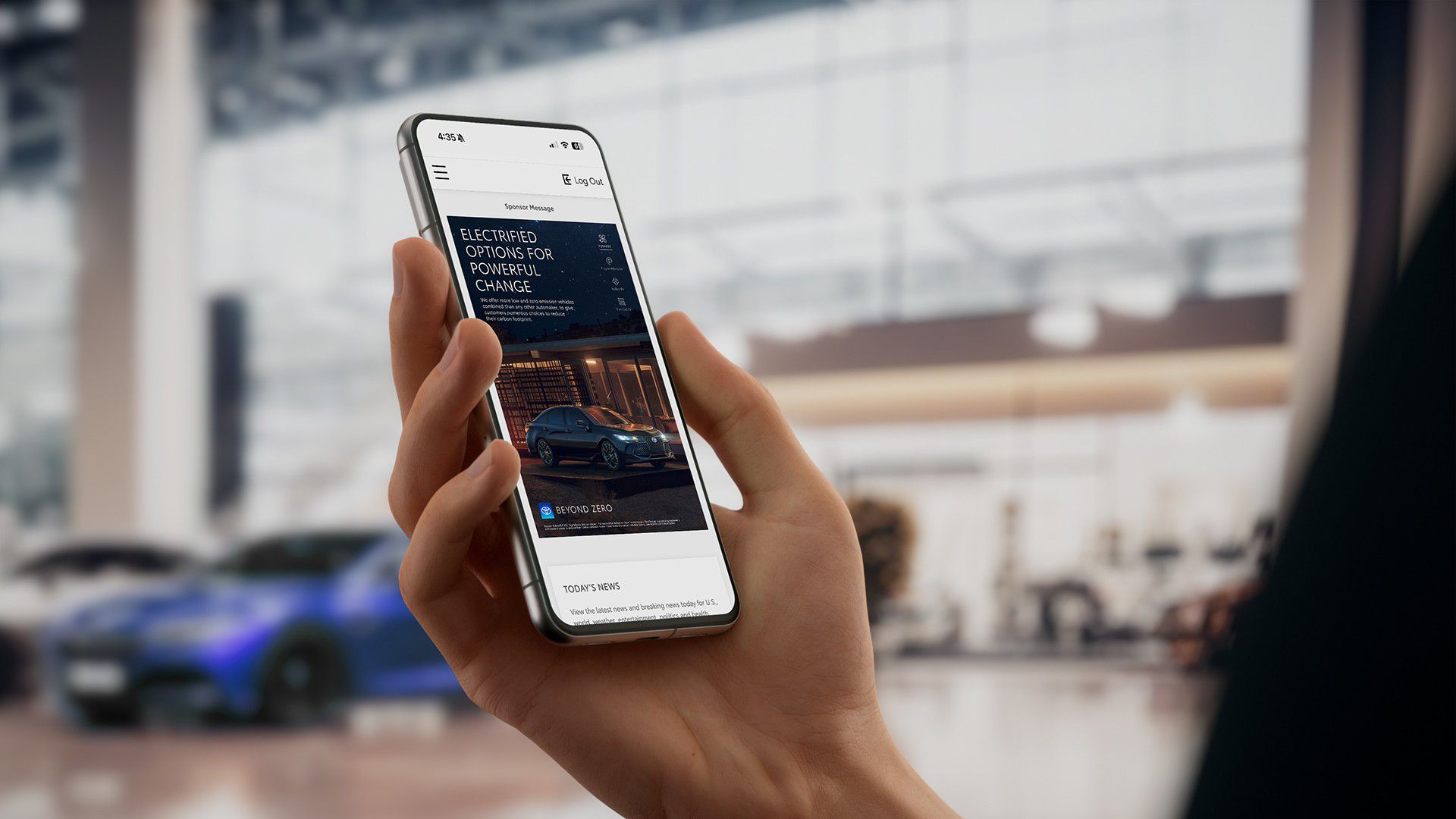 Image of a woman holding a phone in a dealership. On the screen is a Toyota website showing information about our electrified vehicle options.