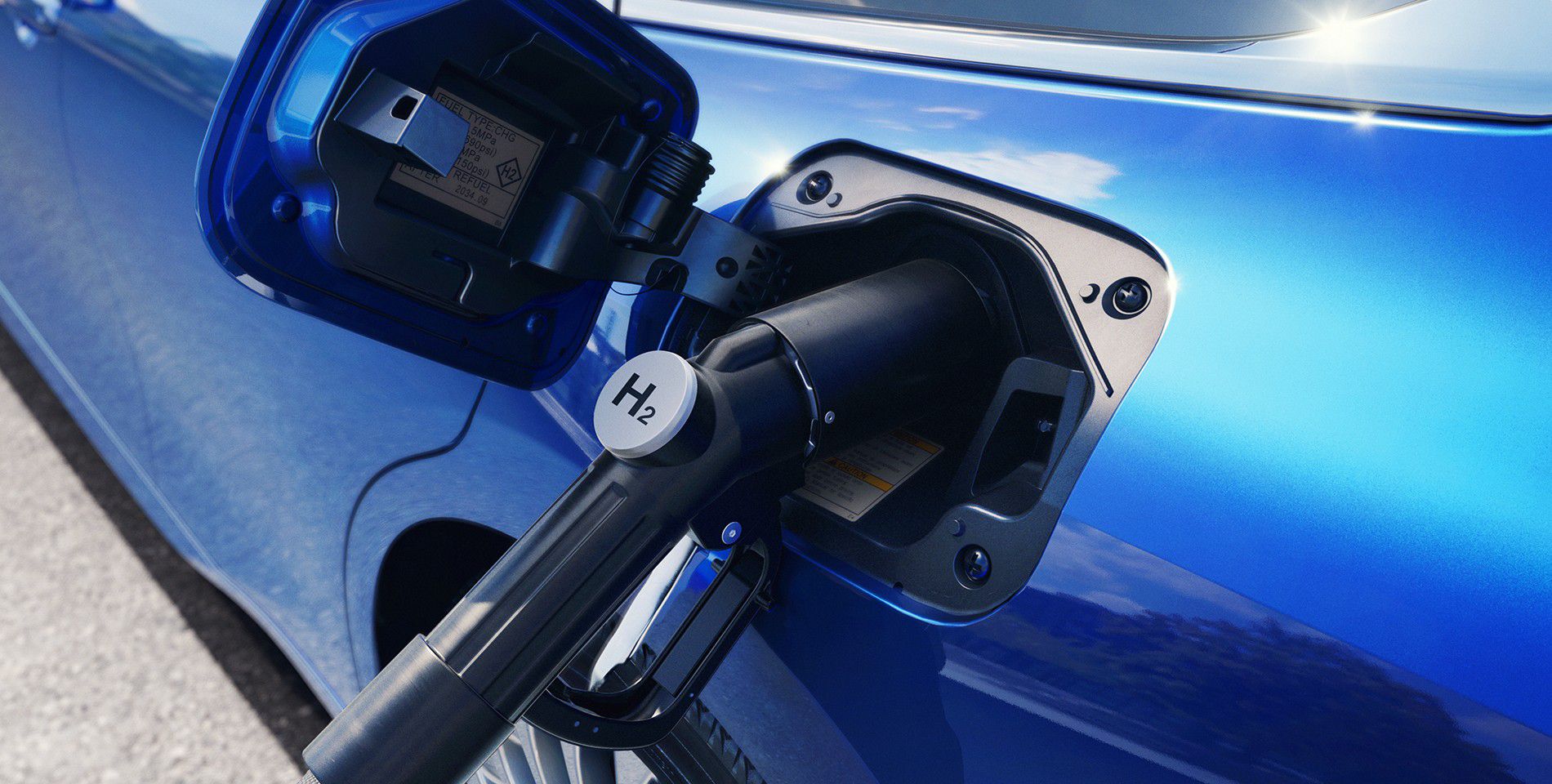A close up of a hydrogen fuel pump charging a blue Toyota Mirai.