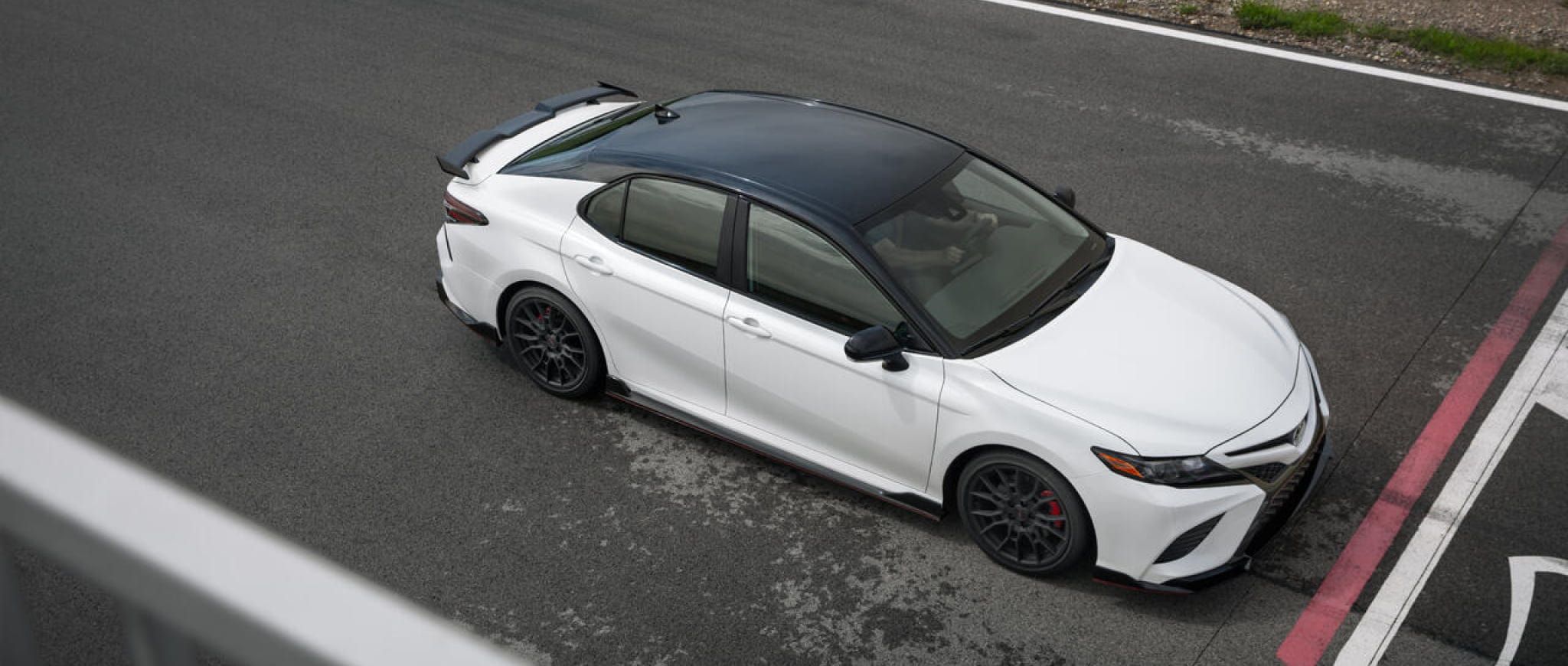 A white 2022 Camry TRD on a racetrack.