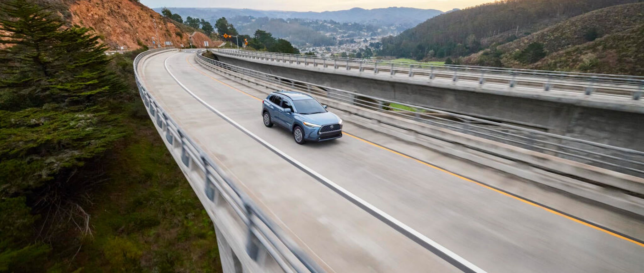 A 2022 Toyota Corolla Cross driving on a mountain highway.