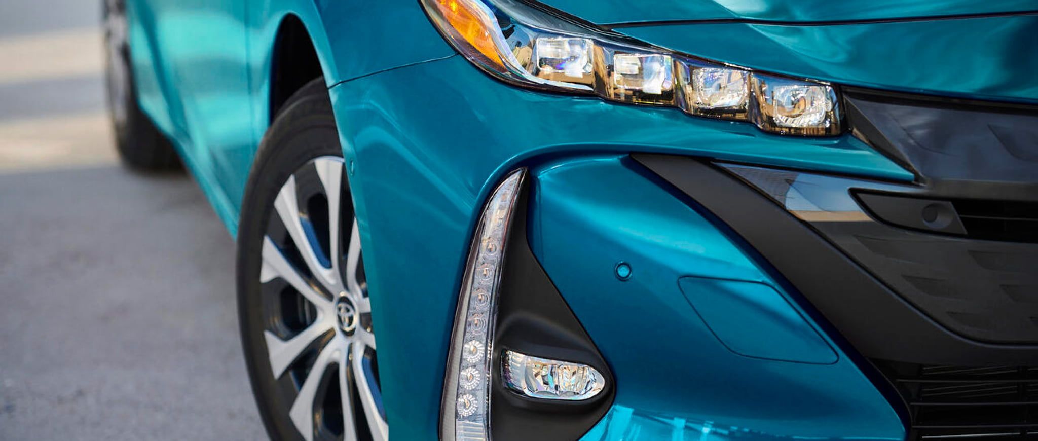 The front corner and headlight of a 2022 Toyota Prius Prime.