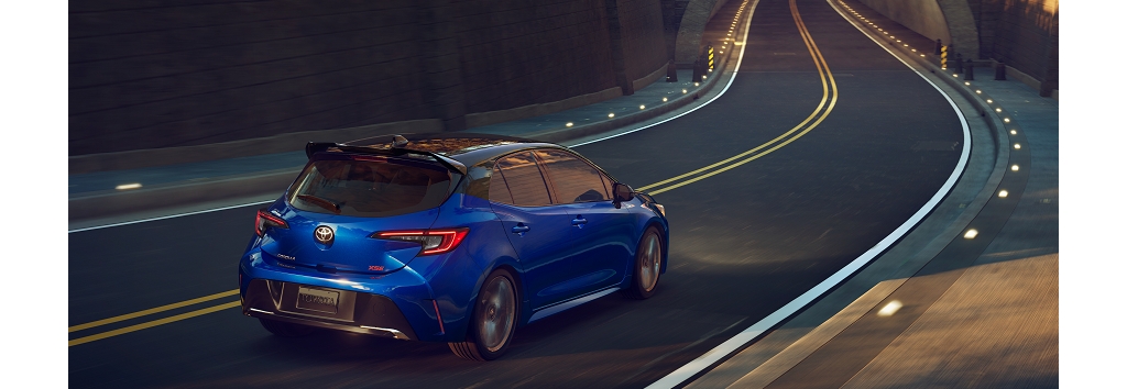 2023 Corolla Hatchback XSE shown in Blue Crush Metallic with Midnight Black Metallic roof, an extra cost color, and available accessory rear window spoiler.