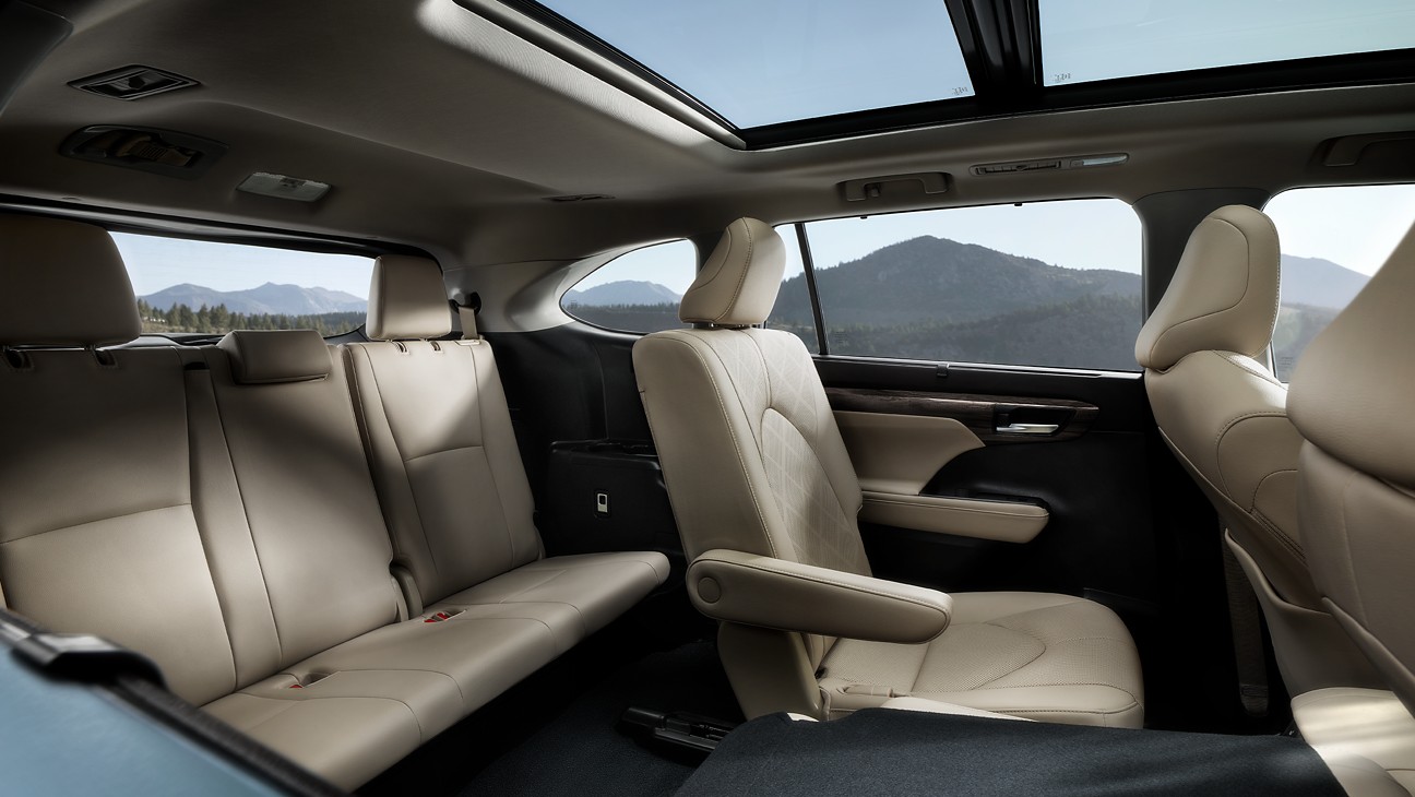 the interior of an suv showcasing all 3 rows of seats and a sun and moon roof