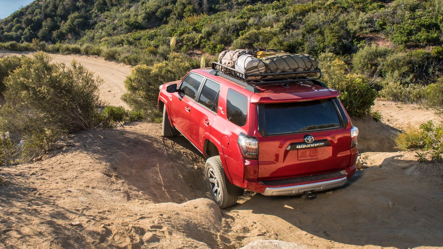 2025 Toyota 4Runner TRD Pro with full roof camping rack rock crawling in the desert