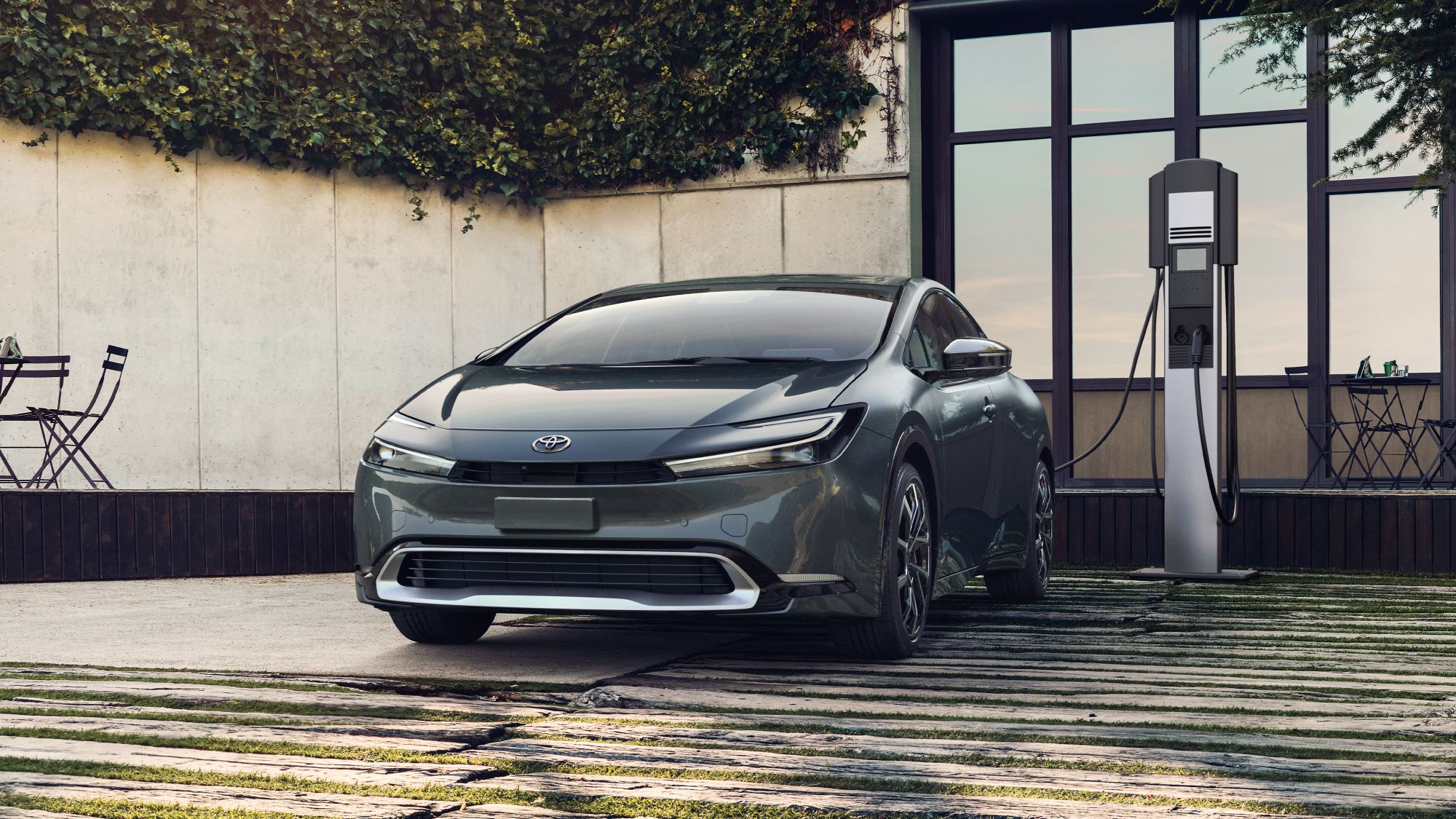 2024 Toyota Prius XSE Premium EV shown in Guardian Gray charging at docking station