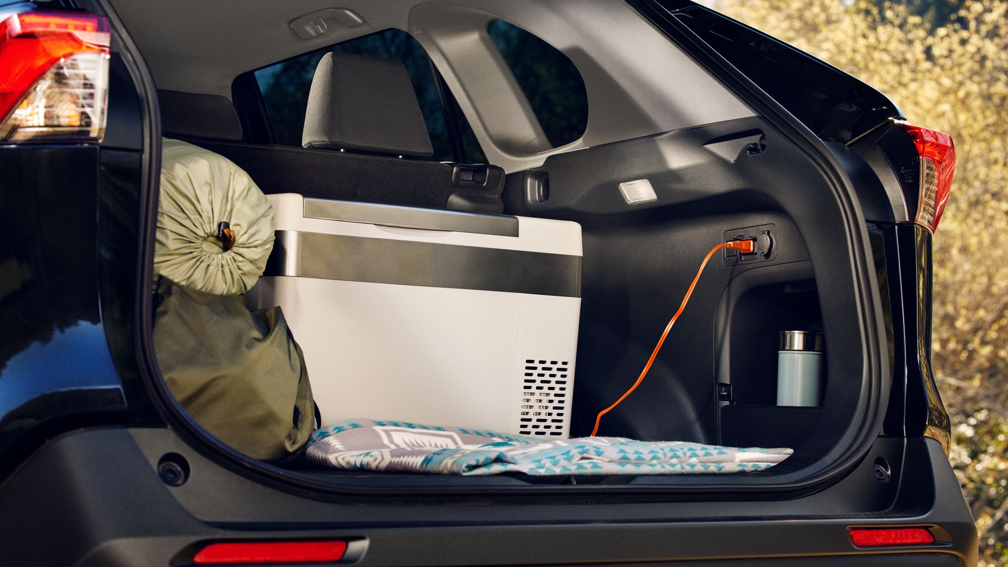 Toyota RAV4 open trunk with camping supplies and 15amp 120volt electrical receptacle