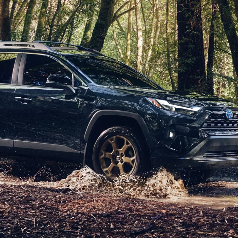 a rav4 driving through the mud