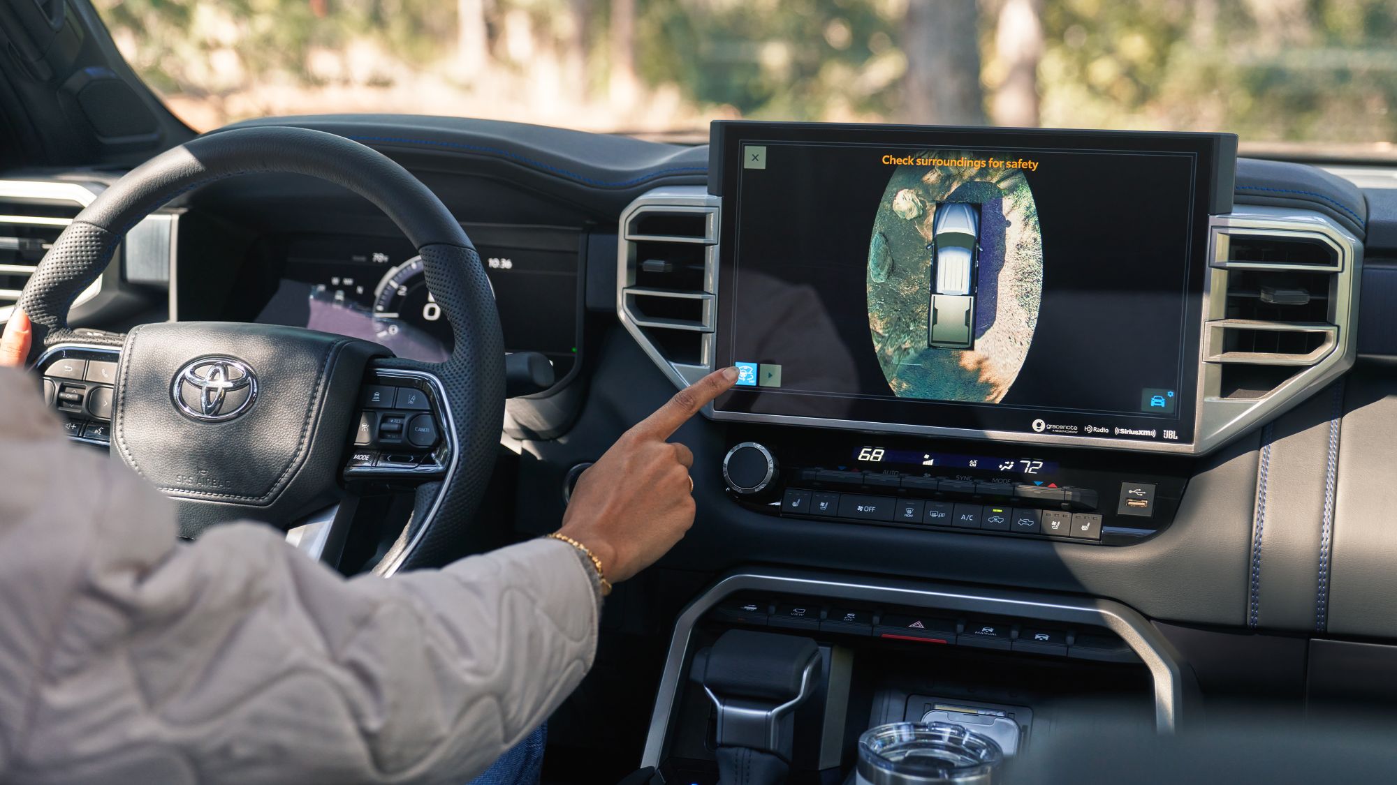 Person using the Panoramic view monitor in the PLatinum CrewMAx Toyota Tundra with black interior