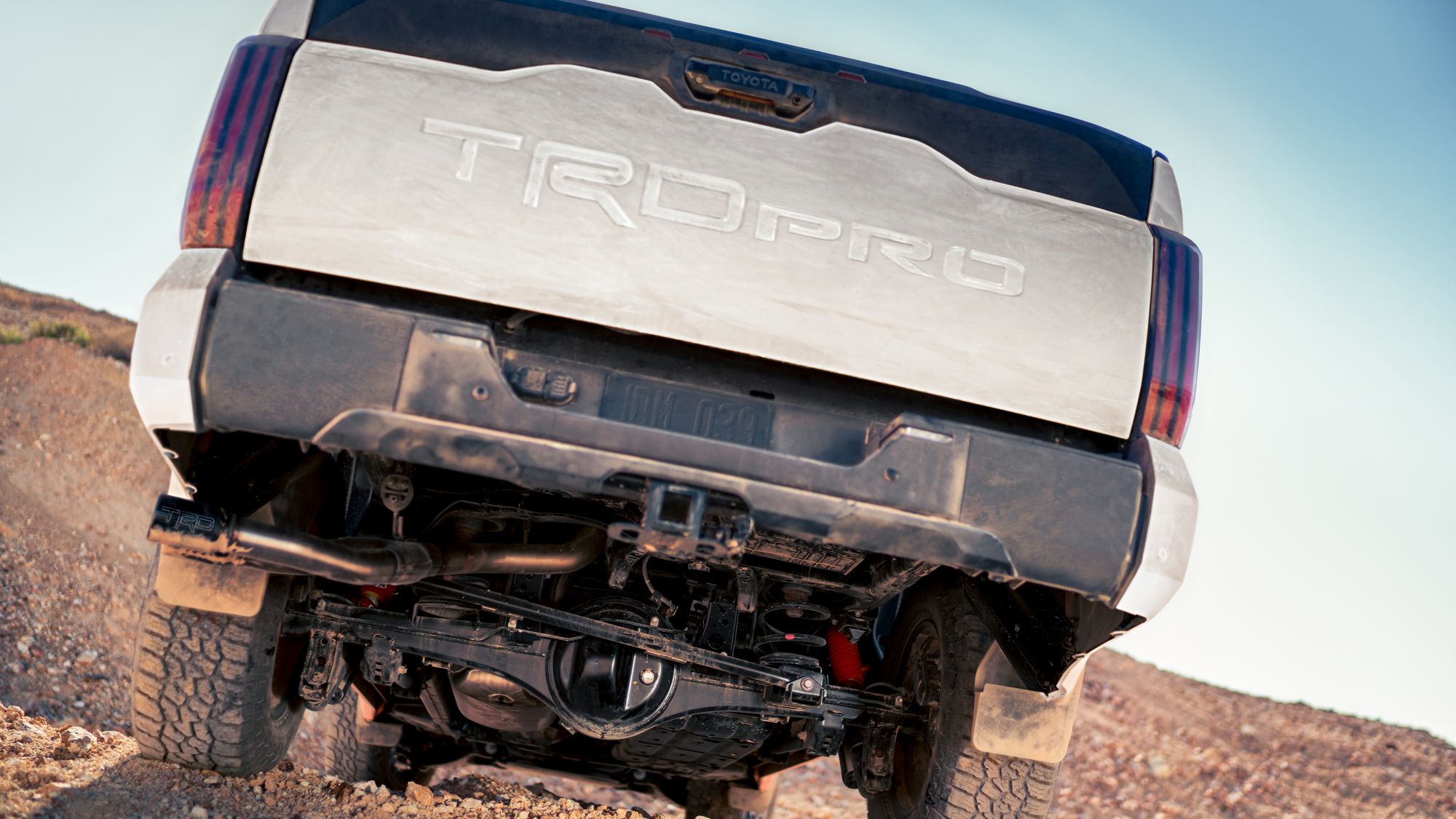 Rear underside of the silver 2024 Toyota Tundra TRD PRO suspension and drivetrain