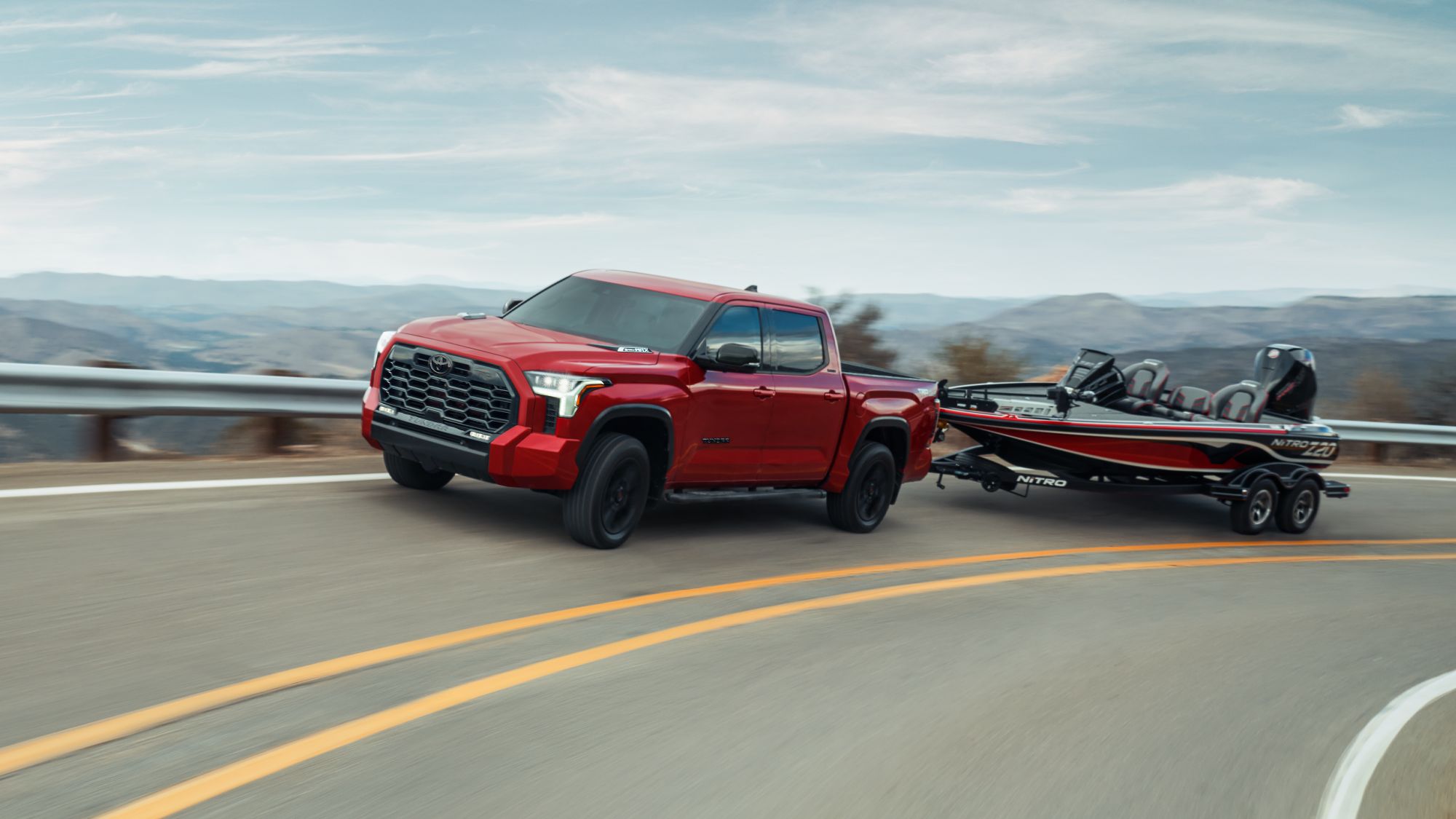 a red truck hauling a boat