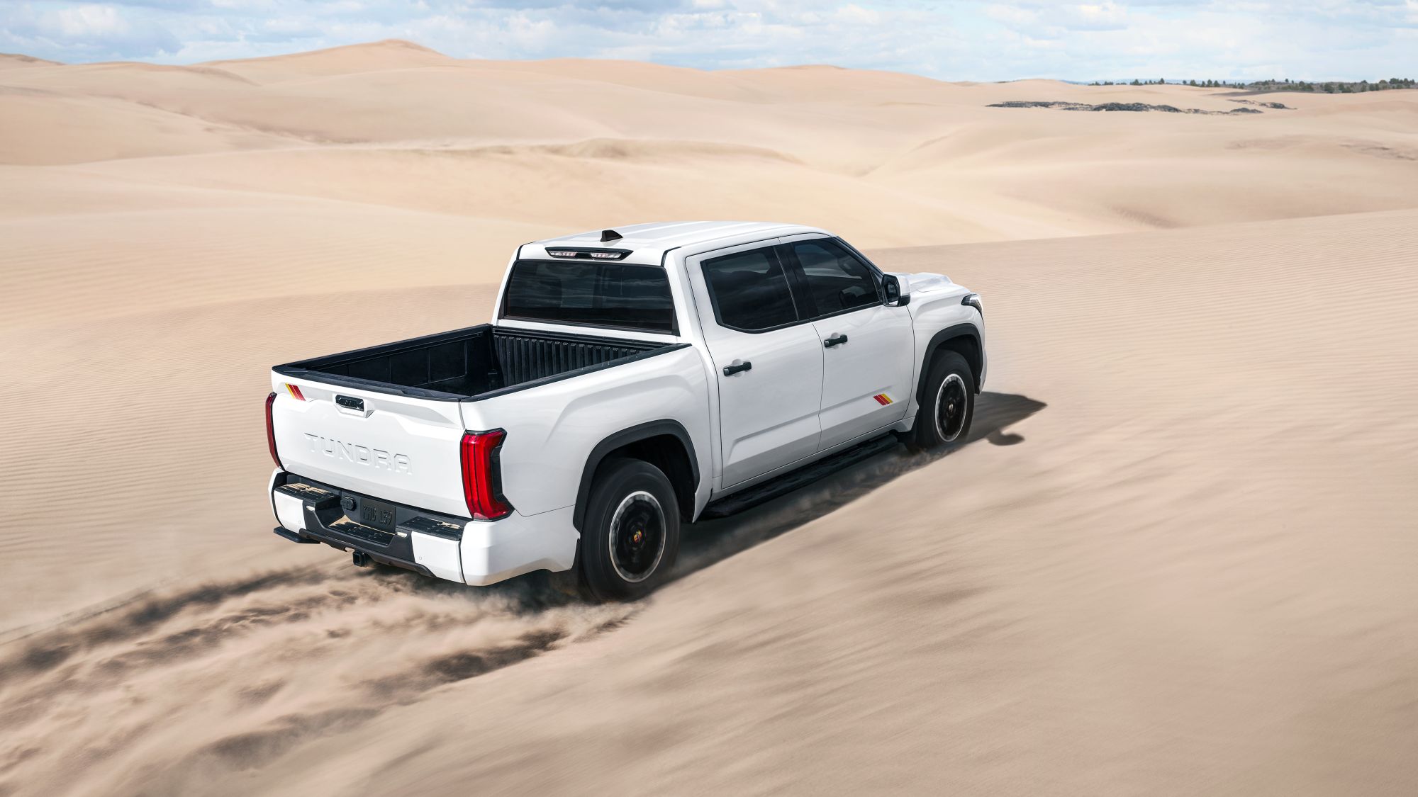 White 2025 Toyota Tundra driving through desert