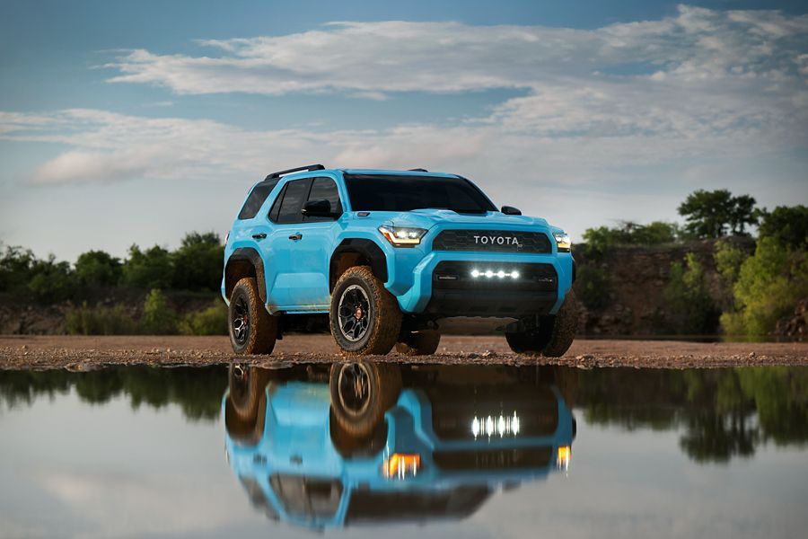Toyota 4Runner parked beside a still lake