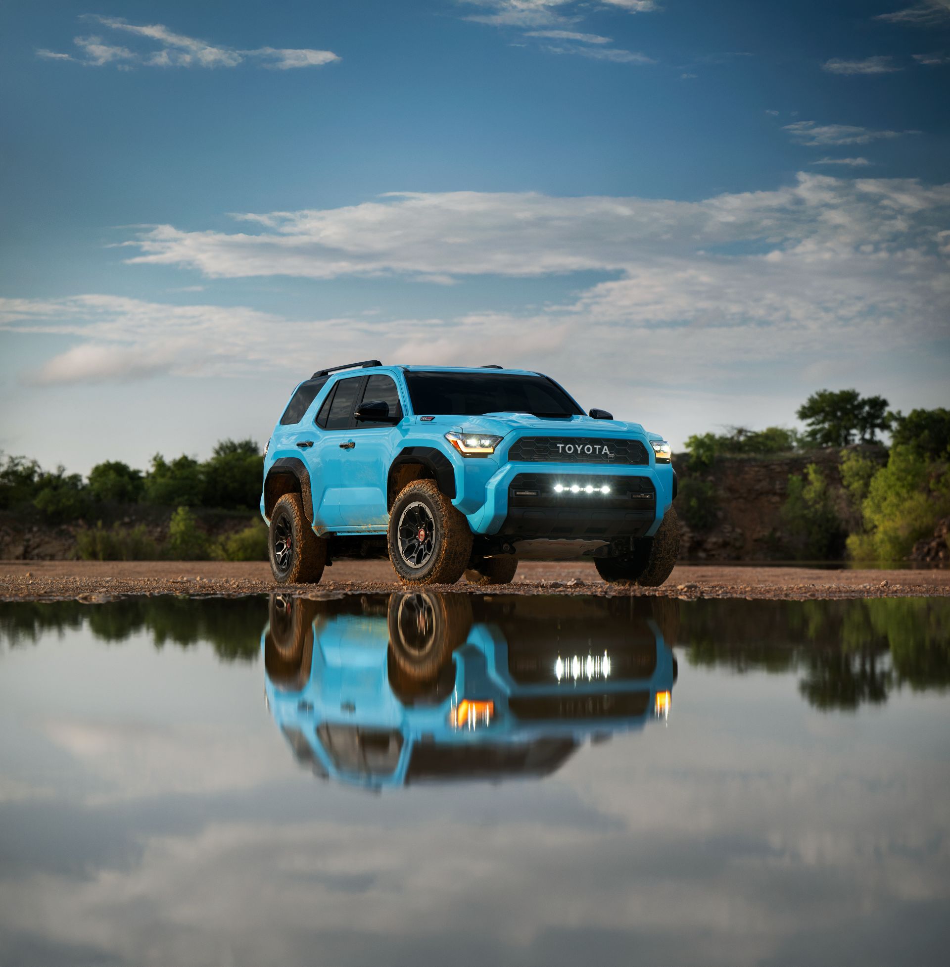 Toyota 4Runner parked beside a still lake