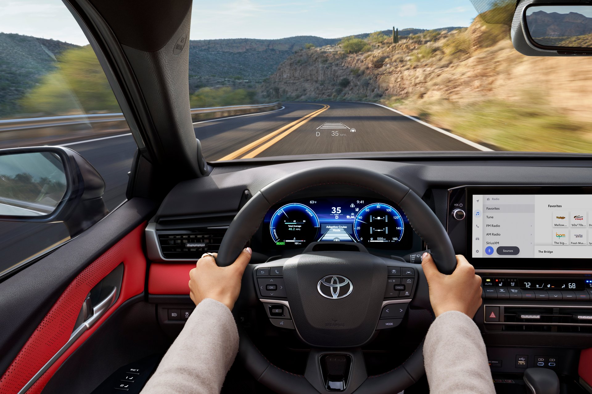 Driver's hands on the steering wheel of a 2026 Toyota Camry on a highway