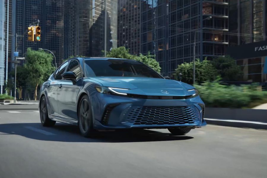 Toyota Camry driving through a city