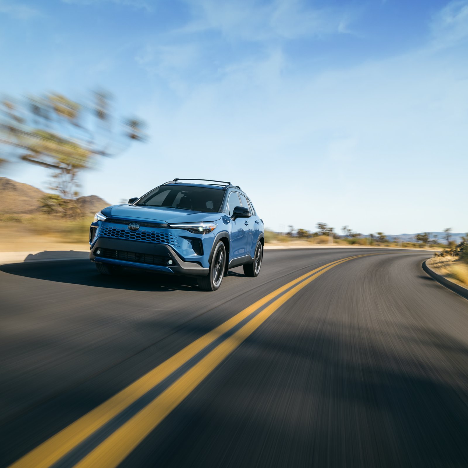 Toyota Corolla Cross driving on a desert highway