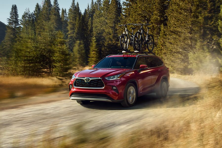Red Toyota Highlander on a dirt road