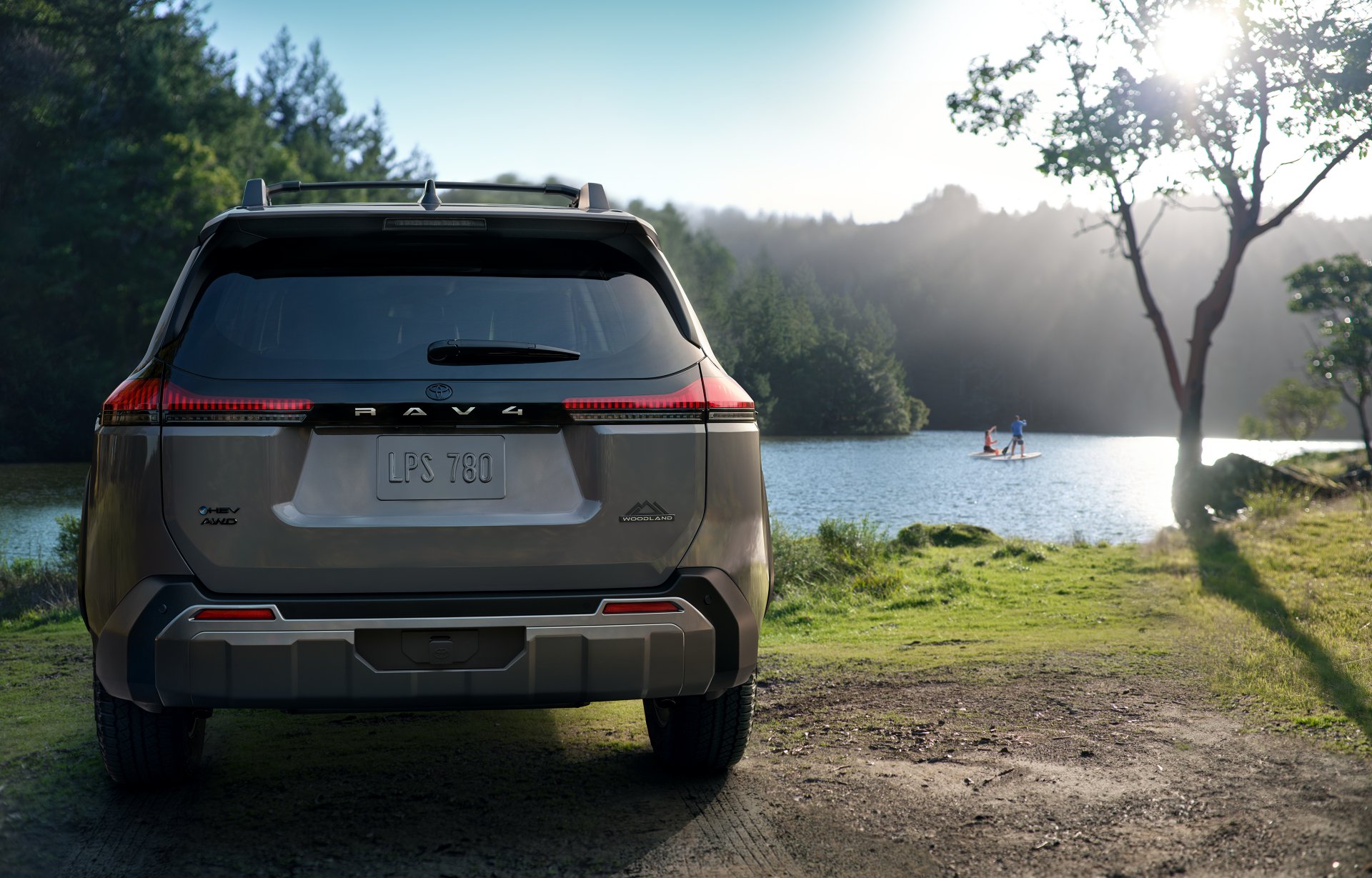 Rear view of a 2026 Toyota RAV4 parked beside a lake