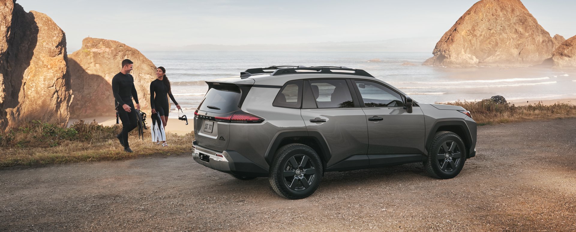 Illustrative: a gray 2026 Toyota RAV4 compact SUV parked on a coastal overlook