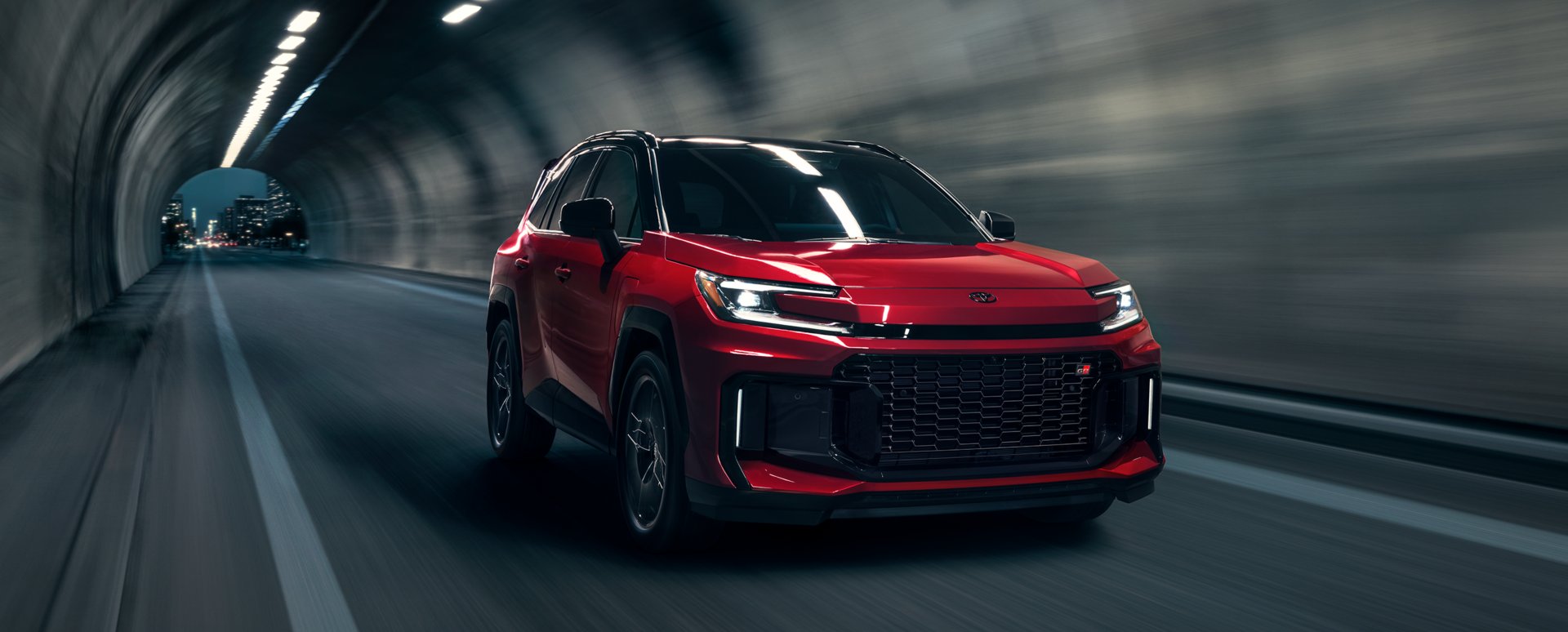 A red 2026 Toyota RAV4 Plug-in Hybrid GR Sport driving through a tunnel