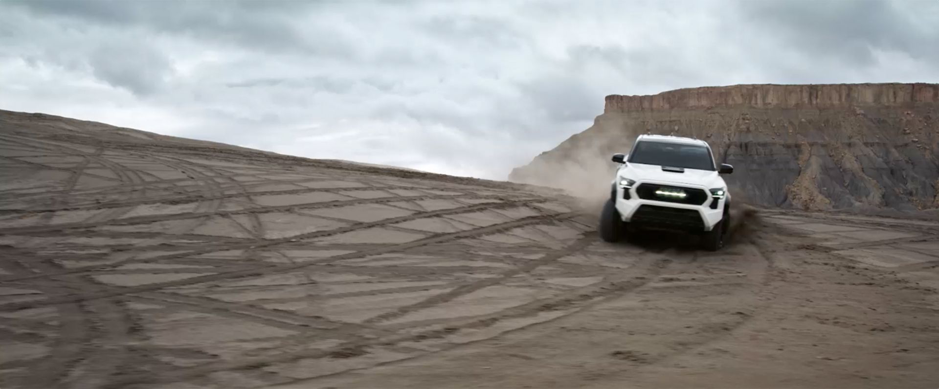 Toyota Tacoma kicking up dust in the desert